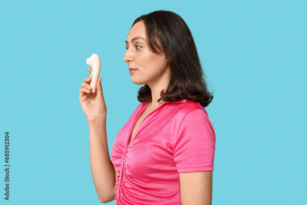 Beautiful young woman with vibrator on blue background Beautiful young woman with vibrator on blue background