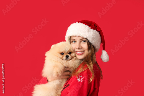 Young woman in Santa hat wi...