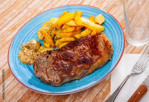 Image of a delicious juicy grilled beef steak and fried potatoes...