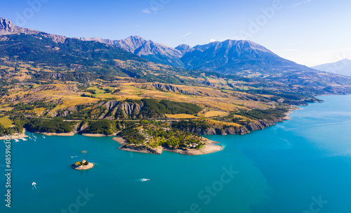 Serene summer landscape of Lake Serre-Poncon, artificial lake surrounded by French Alps, Provence-Alpes-Cote d Azur region