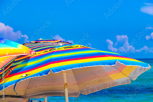 Fototapeta Naklejka Na Ścianę i Meble -  Colorful parasol with many colors on the Caribbean beach in Mexico.
