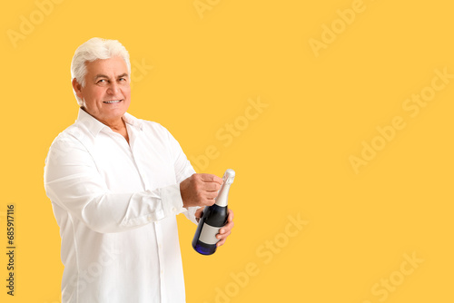 Senior man with bottle of c...