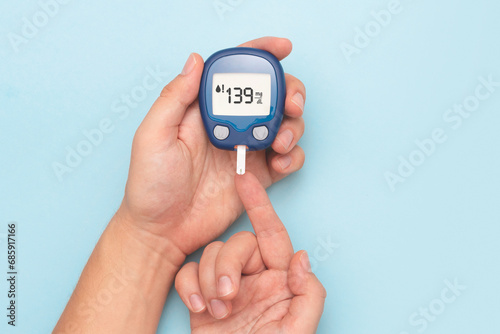 Man using glucometer, blood glucose test photo