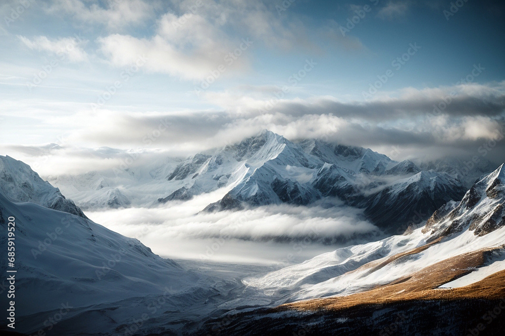 Fototapeta premium High mountains covered with snow and clouds