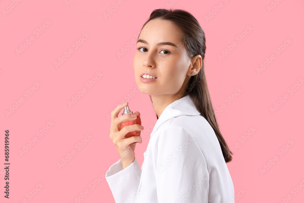 Elegant young woman with perfume on pink background, closeup Elegant young woman with perfume on pink background, closeup