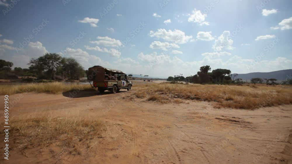 Following Safari Vehicle Through Dirt Road Following Safari Vehicle Through Dirt Road