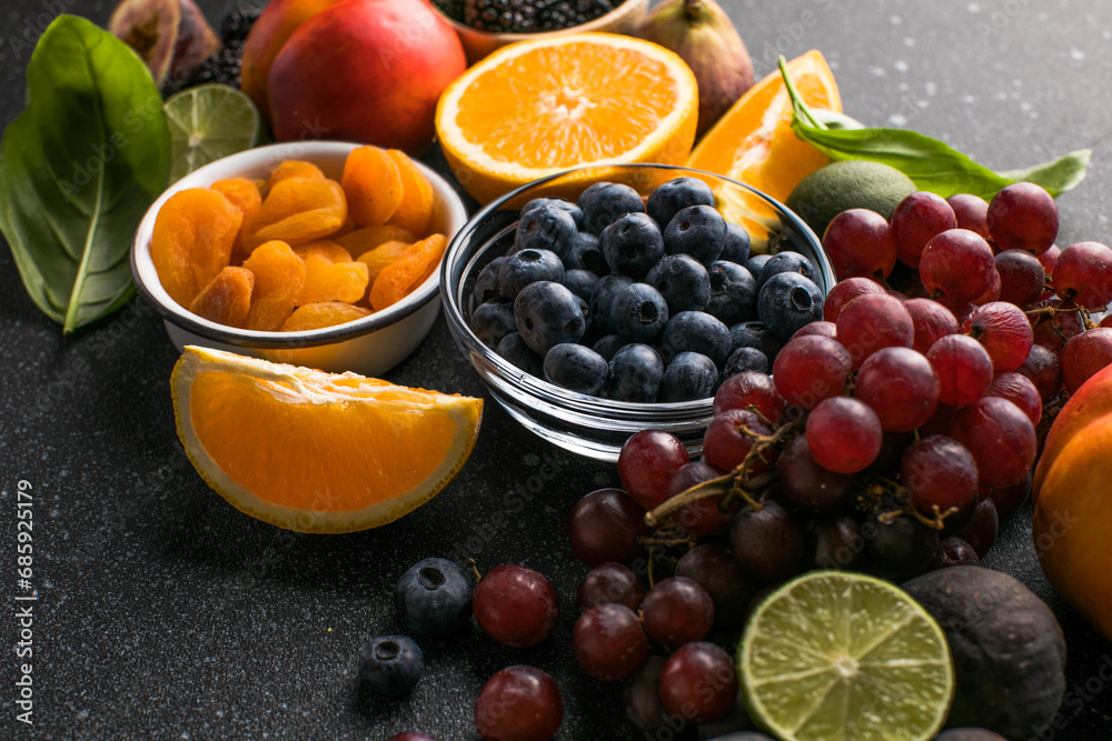 Assortment of fresh exotic fruits and berries on concrete table, flat lay Assortment of fresh exotic fruits and berries on concrete table, flat lay
