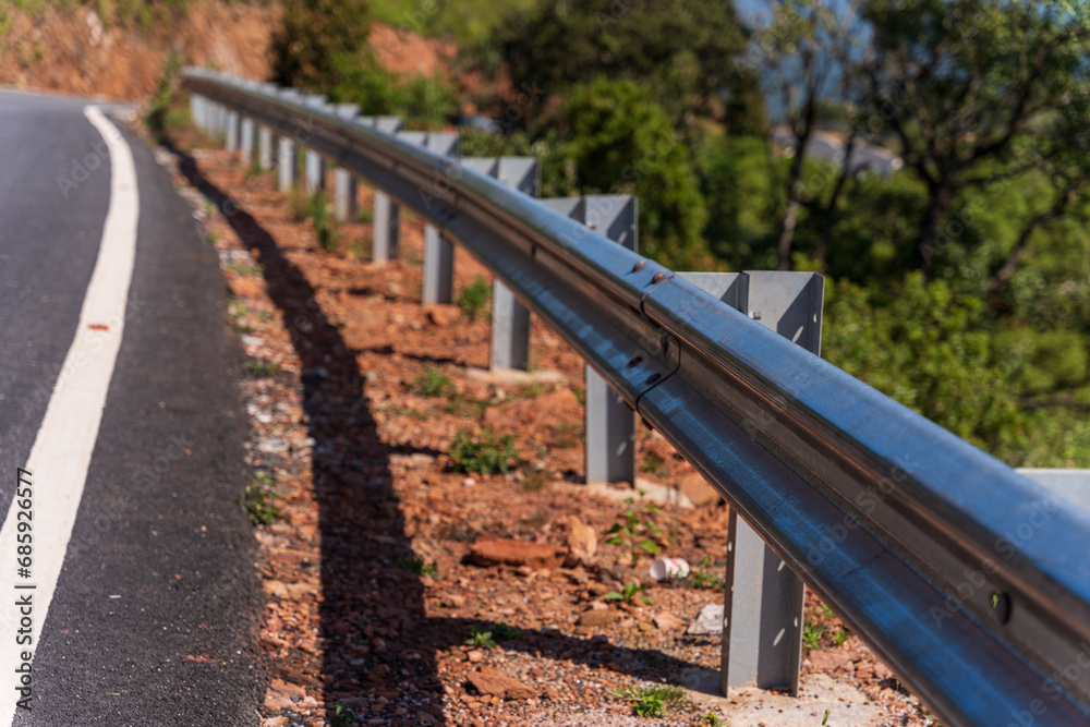 The guard rail, barrier on wayside with cloudy and hill. the straight line from highway fence. image from background, highway fence