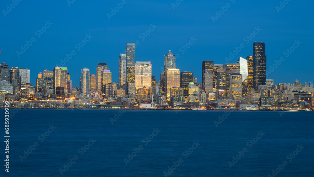 Evening blue sky and water with Seattle downtown illumined with building lights