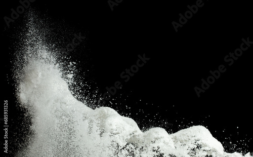 Explosion of snow falling down from sky or roof, heavy big small size snows. Freeze shot on black background isolated. Fluffy White snowflakes splash explode cloud up in mid air storm photo