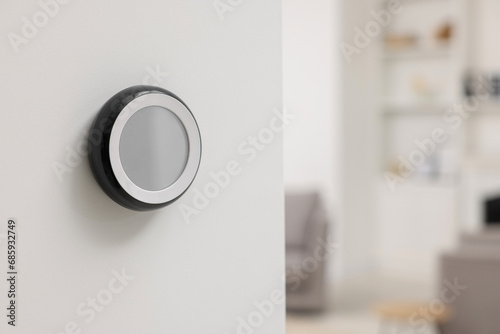 One thermostat on white wall indoors, space for text. Smart home system photo