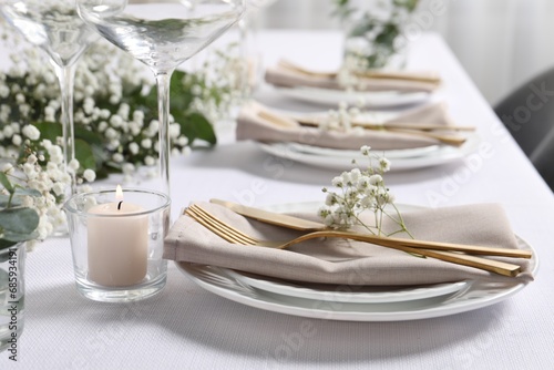 Beautiful table setting with floral decor and candle, closeup