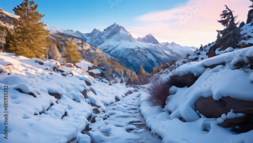 Winding mountain paths disappear into the vast snowfields, presenting a serene winter landscape
