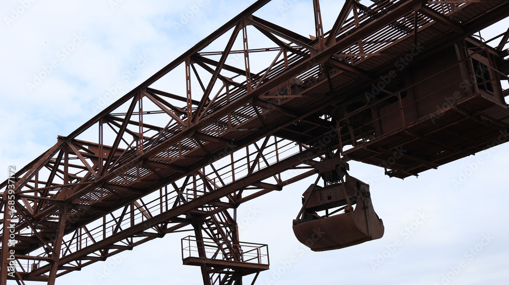 Building structure of rusty steel with stairs in construction, blue sky