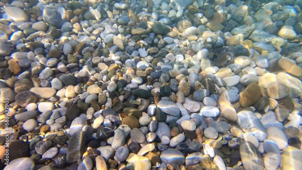 Underwater slow motion video of pebbles on the bottom in the Mediterranean sea. Crete, Greece. Underwater slow motion video of pebbles on the bottom in the Mediterranean sea. Crete, Greece.