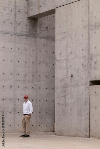 Adult man in suit against wall