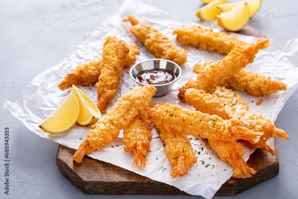 Cooked tempura shrimp on a serving board with dipping sauce Cooked tempura shrimp on a serving board with dipping sauce