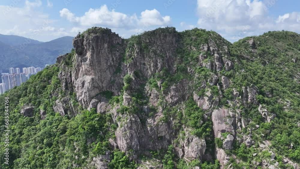 Lion Rock mountain in Kowloon Peninsula Hong Kong sunny aerial drone skyview shot. Popular travel destination in Asia. China. Rock climbing cliffs Lion Rock mountain in Kowloon Peninsula Hong Kong sunny aerial drone skyview shot. Popular travel destination in Asia. China. Rock climbing cliffs