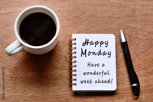 Obraz na płótnie Happy monday with motivation quote on notebook with coffee cup and pen