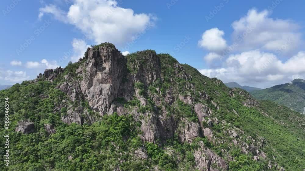 Lion Rock mountain in Kowloon Peninsula Hong Kong sunny aerial drone skyview shot. Popular travel destination in Asia. China. Rock climbing cliffs Lion Rock mountain in Kowloon Peninsula Hong Kong sunny aerial drone skyview shot. Popular travel destination in Asia. China. Rock climbing cliffs