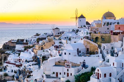 Sunset at the Island Of Santorini Greece, beautiful whitewashed village Oia with church and windmill during sunset, Greek Mediterranean Cyclades Island