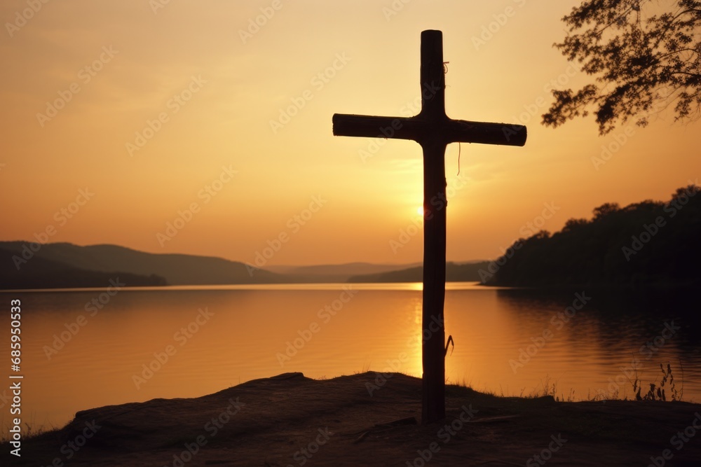 A cross is silhouetted against the sunset at a lake. Generative AI.