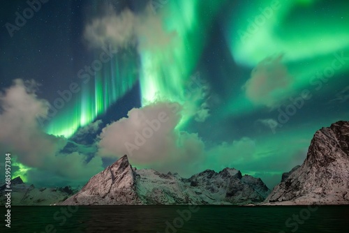 Northern Lights (Aurora Borealis) over mountains in winter, Olstinden, Hamnoy, Reine, Moskenesoy, Lofoten, Norway, Europe photo