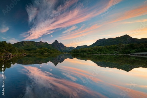 Mountains and clouds reflected in the sea, evening mood, near Sto, Langoya Island, Vesteralen, Northern Norway, Norway, Europe photo