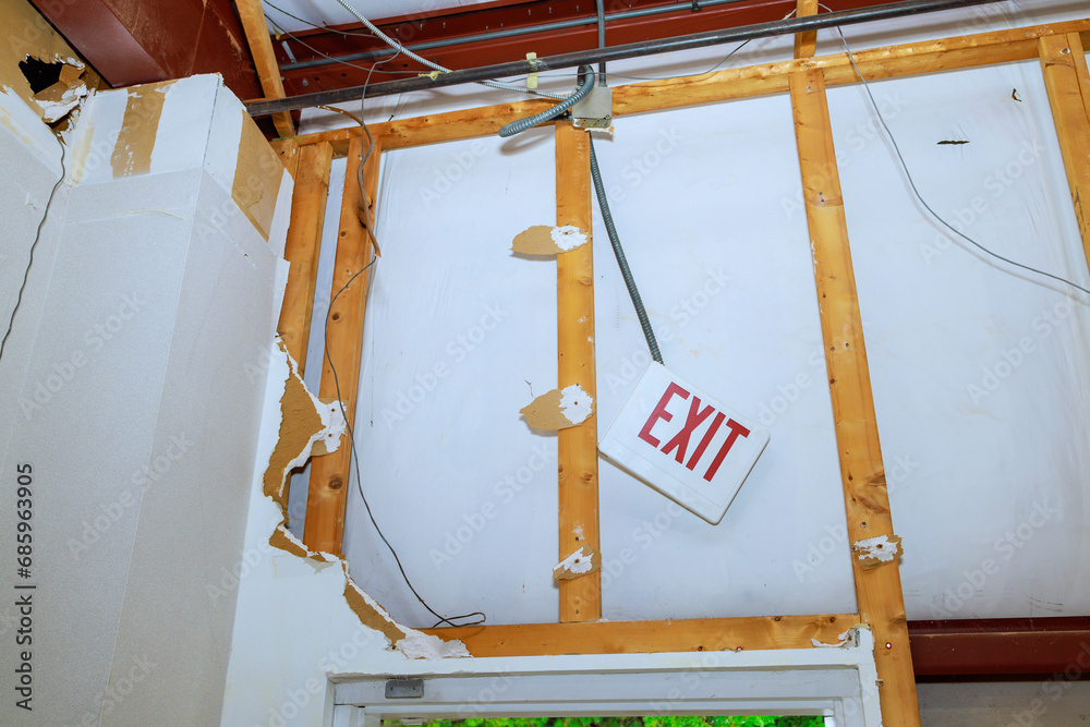 Dismantling damaged plasterboards drywall during construction of residence