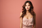 Young Asian woman with a beautiful face in dressed casually set against a pastel colored background.
