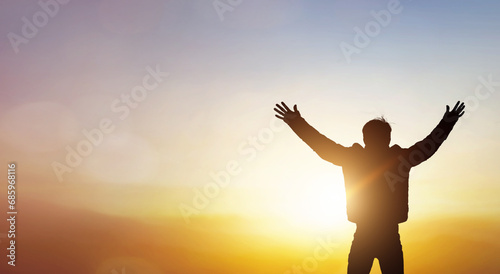 Human hands open palm up worship on sunset background. photo