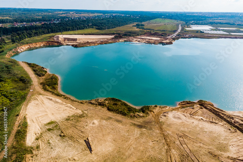 A flooded sand pit with turquoise water. View from high altitude