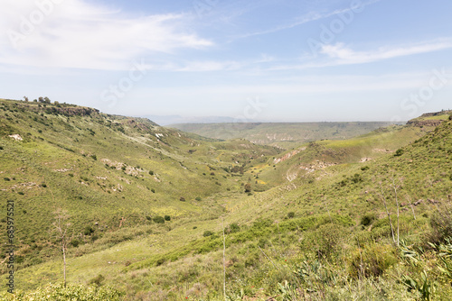 Green valley between hills in the El Al National Nature Reserve located in the northern Galilee in the North of Israel