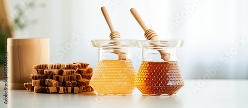 Wooden honeycomb sticks for tea leaves and sugar cane in glass ingredient containers.