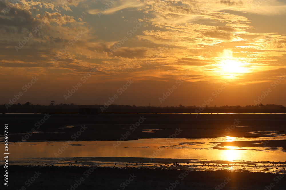 Naklejka premium sunset view in the aie river in assam