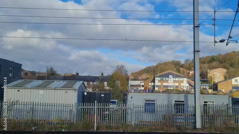 Window Seat View of Outside During Train Moving Fast to Next Station After London. The Train is Traveling from Central London to Luton City of England of UK. Captured on November 20th, 2023 Window Seat View of Outside During Train Moving Fast to Next Station After London. The Train is Traveling from Central London to Luton City of England of UK. Captured on November 20th, 2023