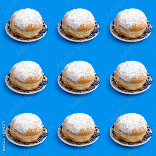 Seamless pattern with traditional Hanukkah doughnut Sufganiyah on blue background. photo