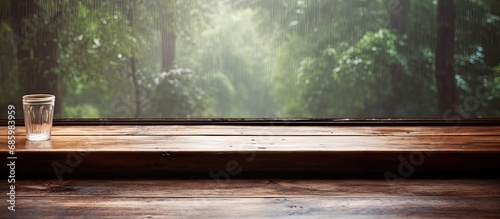 Rainy day's empty wooden table by window
