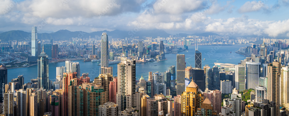 Panoramic view of Hong Kong City  in cloudy day and good weather. View of financial district high-rise and residential buildings from Victoria Peak Observation Deck.