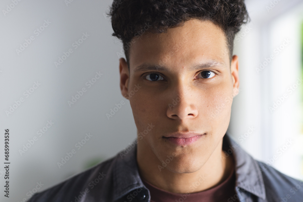 Obraz premium Portrait of serious biracial man in living room at home, copy space