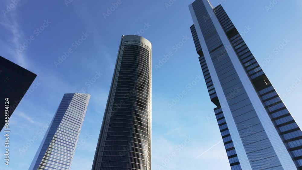 Four skyscraper towers in Madrid on a sunny day with blue skies. Four skyscraper towers in Madrid on a sunny day with blue skies.