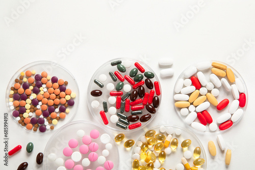 Differents pills and stethoscope on white background. Medicine concept
