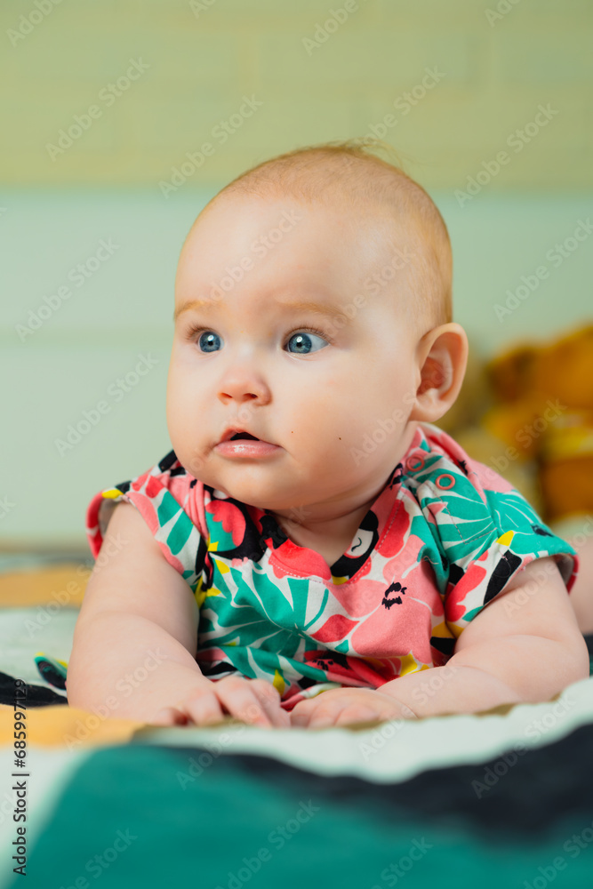 Portrait of a cute baby girl with blue eyes in colorful dress Portrait of a cute baby girl with blue eyes in colorful dress