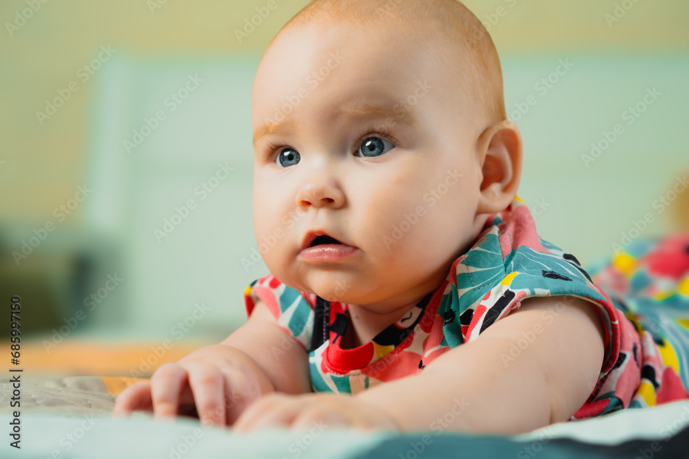 Portrait of a cute baby girl with blue eyes in colorful dress Portrait of a cute baby girl with blue eyes in colorful dress