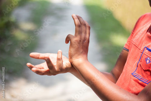 A man has one hand pointing forward and the other hand pointing backwards and blur background © Rokonuzzamnan