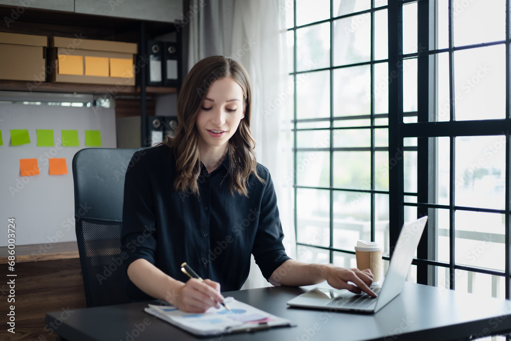 Accountant woman using laptop computer with and working at desk in office, Business statistics and analytic research concept. Accountant woman using laptop computer with and working at desk in office, Business statistics and analytic research concept.