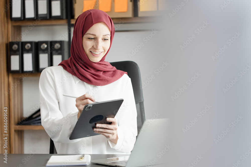 Happy muslim woman working at desk in office, Happy muslim woman working at desk in office,