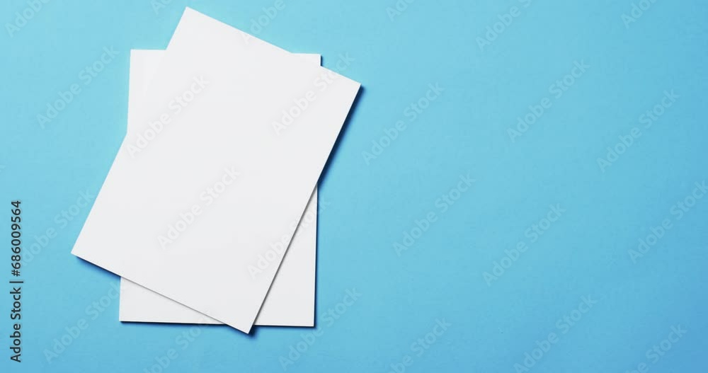 Video of books with white blank pages and copy space on blue background Video of books with white blank pages and copy space on blue background