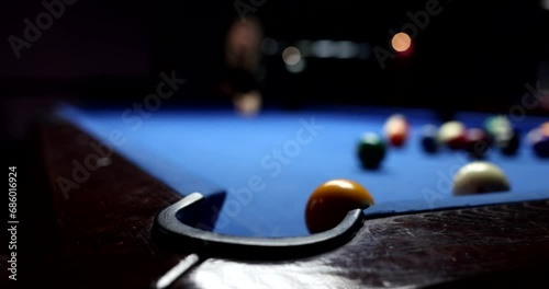 Player hitting ball on table while playing billiards closeup 4k movie slow motion. Entertainment and leisure concept photo