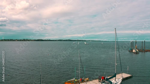 Aerial shot of drone flying above the yachts moored in the marina photo